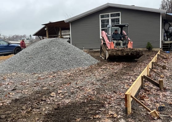 Graded gravel base and formwork prepared ahead of a pour